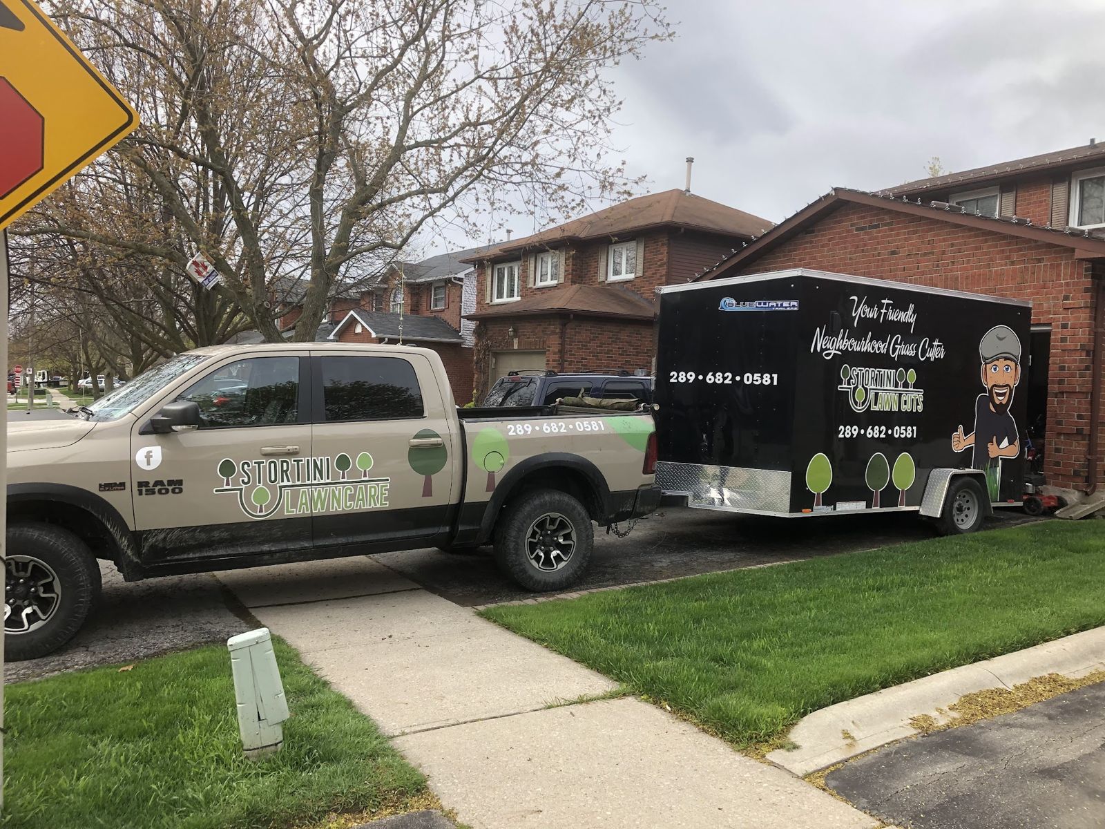 The beige Stortini Lawncare pickup and the black Stortini Lawn Cuts trailer, with its Your Friendly Neighbourhood Grass Cutter decal