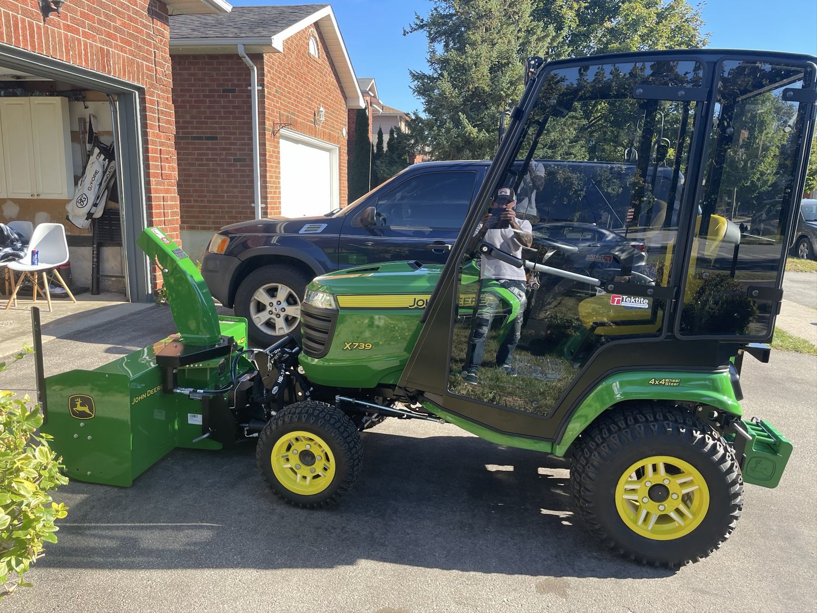 The green cab tractor with its front snowblower, ready for the snow route