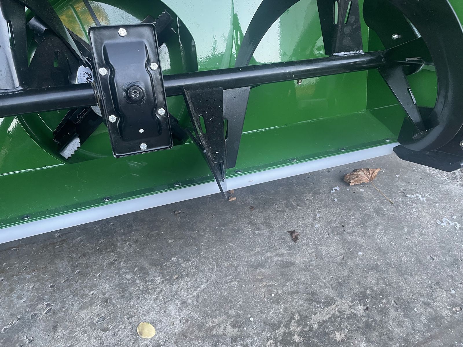 Close-up of the snowblower attachment's auger and housing